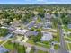 An aerial view shows the neighborhood with lush greenery, single Gathering homes and a clear blue sky at 2708 W Bird St, Tampa, FL 33614