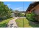 Home's backyard features a covered patio with outdoor seating and a manicured lawn at 2708 W Bird St, Tampa, FL 33614