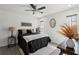 Bedroom with minimalist design featuring a large bed and a gold accent mirror at 2708 W Bird St, Tampa, FL 33614