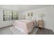 Bright bedroom features a large window, wood-look floors, and cozy decor at 2708 W Bird St, Tampa, FL 33614