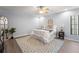 Bright bedroom featuring a ceiling fan, light blue walls, and a decorative rug over wood floors at 2708 W Bird St, Tampa, FL 33614