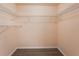 Walk-in closet featuring a built-in shelving system and wood-look flooring at 2708 W Bird St, Tampa, FL 33614