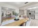 Open concept dining room with a view to a living room and kitchen, with a light color palette at 2708 W Bird St, Tampa, FL 33614