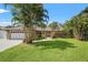 Landscaped front yard with mature trees and a well-maintained lawn leading to the home's entrance at 2708 W Bird St, Tampa, FL 33614