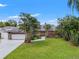 Charming single-story home with mature landscaping, a spacious lawn, and a two-car garage at 2708 W Bird St, Tampa, FL 33614