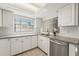 Well lit kitchen featuring granite countertops, stainless steel appliances and a stainless steel dishwasher at 2708 W Bird St, Tampa, FL 33614