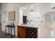 Open kitchen with a granite topped island, wine rack, and stainless steel appliances at 2708 W Bird St, Tampa, FL 33614