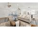 Bright living room with neutral colors, wood ceiling fans, and an open floor plan into the kitchen at 2708 W Bird St, Tampa, FL 33614