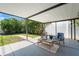Relaxing covered patio with chairs and a table that's perfect for outdoor living at 2708 W Bird St, Tampa, FL 33614