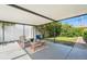 Relaxing covered patio with chairs and a table that's perfect for outdoor living at 2708 W Bird St, Tampa, FL 33614