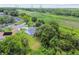 Aerial view of the property showcasing lush landscaping, a neatly kept lawn, and surrounding neighborhood at 2868 Denmarsh Ct, Palm Harbor, FL 34684