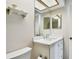 Bathroom featuring white vanity with marble countertop, toilet, and skylight at 2868 Denmarsh Ct, Palm Harbor, FL 34684