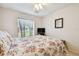 Bedroom featuring floral bedding, ceiling fan, and window with sheer curtain at 2868 Denmarsh Ct, Palm Harbor, FL 34684