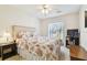 Bedroom featuring floral bedding, ceiling fan, and window at 2868 Denmarsh Ct, Palm Harbor, FL 34684