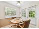 Charming breakfast nook with sunny window and French doors, ideal for casual dining and relaxation at 2868 Denmarsh Ct, Palm Harbor, FL 34684