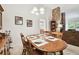 Formal dining room featuring a wooden table set for four and stone fireplace at 2868 Denmarsh Ct, Palm Harbor, FL 34684