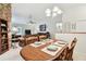 Dining area with a wooden table and seating, flowing into the living room and kitchen at 2868 Denmarsh Ct, Palm Harbor, FL 34684