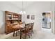Dining room with wooden hutch and view into the kitchen with stainless steel appliances at 2868 Denmarsh Ct, Palm Harbor, FL 34684