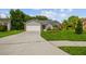 Well-maintained home boasts a manicured lawn and spacious driveway at 2868 Denmarsh Ct, Palm Harbor, FL 34684