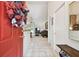 Welcoming foyer featuring tile flooring, a coat closet, and a glimpse into the living room at 2868 Denmarsh Ct, Palm Harbor, FL 34684