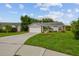 Inviting one-story home with manicured lawn, mature trees and long driveway at 2868 Denmarsh Ct, Palm Harbor, FL 34684