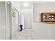 Tiled hallway with a view of the front door, closet, and decorative cabinet at 2868 Denmarsh Ct, Palm Harbor, FL 34684