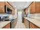 Modern kitchen features stainless steel appliances, light countertops, and ample cabinet storage at 2868 Denmarsh Ct, Palm Harbor, FL 34684