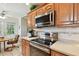 Kitchen with stainless steel appliances, wood cabinets and an eat-in kitchen setup at 2868 Denmarsh Ct, Palm Harbor, FL 34684