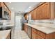 Bright kitchen features stainless steel appliances, wood cabinets, and white countertops at 2868 Denmarsh Ct, Palm Harbor, FL 34684