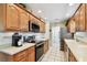 Modern kitchen features stainless steel appliances, light countertops, and ample cabinet storage at 2868 Denmarsh Ct, Palm Harbor, FL 34684