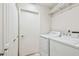 Laundry area featuring a washer, dryer and storage shelves at 2868 Denmarsh Ct, Palm Harbor, FL 34684