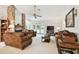 Comfortable living room with a stone fireplace, ceiling fan, and access to the backyard at 2868 Denmarsh Ct, Palm Harbor, FL 34684