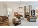 Spacious living room with stone fireplace, plush sofas, and an open layout at 2868 Denmarsh Ct, Palm Harbor, FL 34684