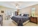Comfortable main bedroom with a ceiling fan, walk-out patio and light-filled windows at 2868 Denmarsh Ct, Palm Harbor, FL 34684