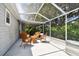 The screened patio provides a comfortable outdoor space with wicker seating and access to the backyard at 2868 Denmarsh Ct, Palm Harbor, FL 34684