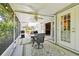 The screened patio features a ceiling fan, dining table and direct access to the home's interior at 2868 Denmarsh Ct, Palm Harbor, FL 34684