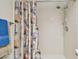 Shower featuring beige tile surround and nautical themed shower curtain at 2868 Denmarsh Ct, Palm Harbor, FL 34684