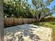 An exterior shot showing the backyard, patio, mature trees and privacy fence at 3018 11Th N Ave, St Petersburg, FL 33713