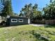 An exterior shot showing the backyard, back of house, a patio and a privacy fence at 3018 11Th N Ave, St Petersburg, FL 33713