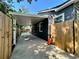 An exterior shot showing the carport next to the house with privacy fence at 3018 11Th N Ave, St Petersburg, FL 33713
