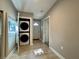 Hallway features tile flooring, stacked washer and dryer, and doorway at 3018 11Th N Ave, St Petersburg, FL 33713