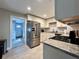 Updated kitchen features stainless steel appliances, granite countertops, and subway tile backsplash at 3018 11Th N Ave, St Petersburg, FL 33713