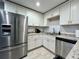 Bright kitchen featuring stainless steel appliances, granite countertops, and white cabinets at 3018 11Th N Ave, St Petersburg, FL 33713