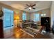 Comfortable living room with hardwood floors, ceiling fan, large sofa, and natural light at 3018 11Th N Ave, St Petersburg, FL 33713