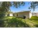 Well-maintained backyard featuring lush green grass and a modern A/C unit ensuring a comfortable home environment at 30260 Birdhouse Dr, Wesley Chapel, FL 33545