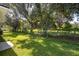 Large backyard with mature trees, offering a serene and private outdoor space for relaxation and recreation at 30260 Birdhouse Dr, Wesley Chapel, FL 33545