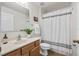 Bathroom with wood cabinets and shower/tub combo at 30260 Birdhouse Dr, Wesley Chapel, FL 33545
