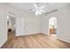 Spacious bedroom featuring wood-look flooring, a ceiling fan, an ensuite bathroom, and a walk-in closet at 30260 Birdhouse Dr, Wesley Chapel, FL 33545