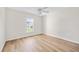 Bright bedroom with wood-look flooring and a ceiling fan at 30260 Birdhouse Dr, Wesley Chapel, FL 33545