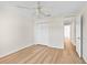 Bedroom with wood-look flooring, ceiling fan, and closet at 30260 Birdhouse Dr, Wesley Chapel, FL 33545
